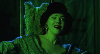 Movie still from “Beetlejuice” (1988), directed by Tim Burton – A person wearing a hat and holding an umbrella; Close Up shot, Low angle