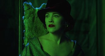 Movie still from “Beetlejuice” (1988), directed by Tim Burton – A woman wearing a hat and a green light; Close Up shot, Low angle