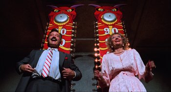 Movie still from “Beetlejuice” (1988), directed by Tim Burton – A man and a woman standing next to each other; Medium shot, Low angle