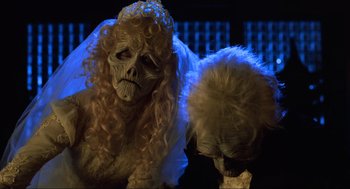 Movie still from “Beetlejuice” (1988), directed by Tim Burton – A woman dressed up as a bride for a halloween event; Close Up shot, Low angle