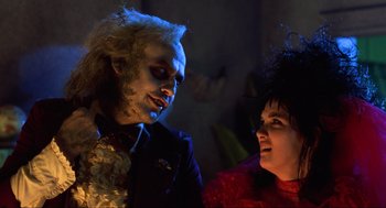Movie still from “Beetlejuice” (1988), directed by Tim Burton – A man and a woman dressed as beetlejuice and lydia from beetlejuice; Close Up shot, Over the shoulder angle