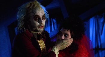 Movie still from “Beetlejuice” (1988), directed by Tim Burton – A man and a woman dressed up as beetlejuice and lydia from beetlejuice; Close Up shot, Over the shoulder angle
