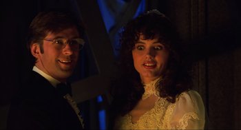 Movie still from “Beetlejuice” (1988), directed by Tim Burton – A man and a woman standing next to each other; Close Up shot, Low angle