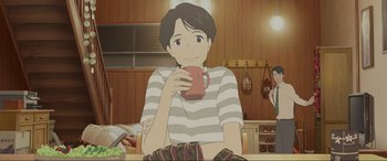 Movie still from “Belle” (2021), directed by Mamoru Hosoda – A man sitting at a table holding a mug; Medium shot, Over the shoulder angle