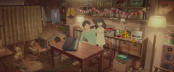 Movie still from “Belle” (2021), directed by Mamoru Hosoda – Two people are sitting at a table with a keyboard; Wide shot, High angle