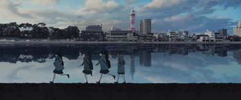Movie still from “Belle” (2021), directed by Mamoru Hosoda – Three women walking along the shore of a lake; Extreme Wide shot, Low angle
