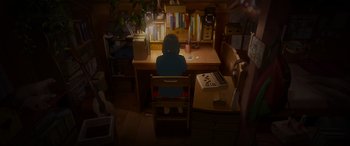 Movie still from “Belle” (2021), directed by Mamoru Hosoda – A person sitting in front of a computer at a desk; Extreme Wide shot, High angle