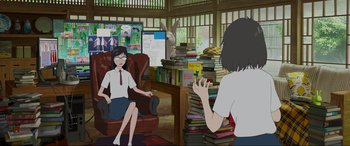Movie still from “Belle” (2021), directed by Mamoru Hosoda – A woman sitting in a chair in front of another woman in a room full of books; Wide shot, Over the shoulder angle