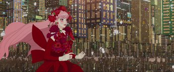 Movie still from “Belle” (2021), directed by Mamoru Hosoda – A woman in a red dress is sitting in front of a city skyline; Wide shot, Low angle