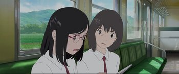 Movie still from “Belle” (2021), directed by Mamoru Hosoda – Two anime girls sitting next to each other on a train; Close Up shot, Over the shoulder angle