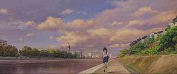 Movie still from “Belle” (2021), directed by Mamoru Hosoda – A woman walking down the side of a river; Extreme Wide shot, Low angle