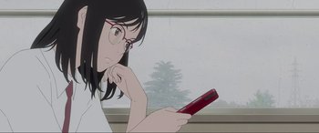 Movie still from “Belle” (2021), directed by Mamoru Hosoda – A woman looking at her cell phone while sitting in front of a window; Close Up shot, Low angle