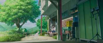 Movie still from “Belle” (2021), directed by Mamoru Hosoda – Two people sitting on a bench near a building; Extreme Wide shot, Low angle