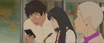 Movie still from “Belle” (2021), directed by Mamoru Hosoda – A man and a woman looking at a phone; Close Up shot, Low angle