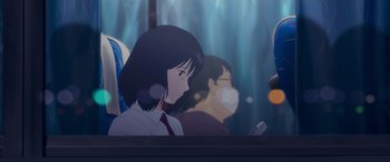 Movie still from “Belle” (2021), directed by Mamoru Hosoda – A woman looking at her cell phone while sitting on a bus; Medium shot, Over the shoulder angle
