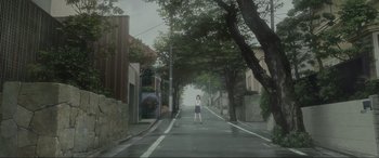 Movie still from “Belle” (2021), directed by Mamoru Hosoda – A girl standing in the middle of the street; Extreme Wide shot, Low angle