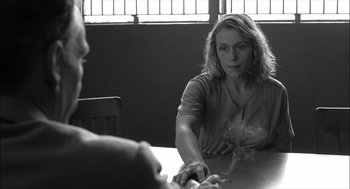Movie still from “The Man Who Wasn't There” (2001), directed by Joel Coen – A woman sitting at a table in front of a man; Medium shot, Over the shoulder angle