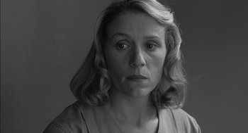 Movie still from “The Man Who Wasn't There” (2001), directed by Joel Coen – Black and white photograph of a woman with a serious look; Close Up shot, Over the shoulder angle