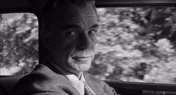 Movie still from “The Man Who Wasn't There” (2001), directed by Joel Coen – Black and white photograph of a man in a car; Close Up shot, Over the shoulder angle
