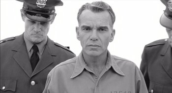 Movie still from “The Man Who Wasn't There” (2001), directed by Joel Coen – A black and white photo of a man in a uniform; Close Up shot, Low angle