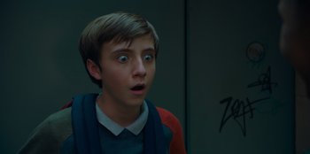 Movie still from “Better Nate Than Ever” (2022), directed by Tim Federle – A young man with a surprised look on his face; Close Up shot, Low angle