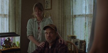 Movie still from “Better Nate Than Ever” (2022), directed by Tim Federle – A woman standing next to a man sitting in a chair; Medium shot, Over the shoulder angle