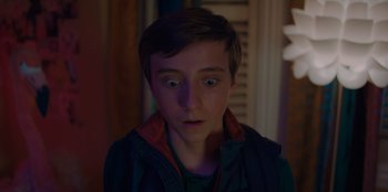 Movie still from “Better Nate Than Ever” (2022), directed by Tim Federle – A young man with a surprised look on his face; Close Up shot, High angle