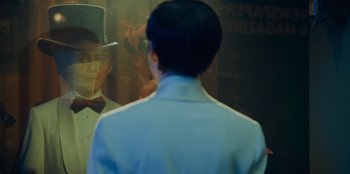 Movie still from “Better Nate Than Ever” (2022), directed by Tim Federle – A man standing in front of a painting of abraham lincoln; Close Up shot, Over the shoulder angle