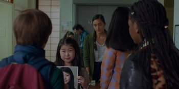 Movie still from “Better Nate Than Ever” (2022), directed by Tim Federle – A group of people standing in a room; Close Up shot, Over the shoulder angle