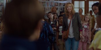 Movie still from “Better Nate Than Ever” (2022), directed by Tim Federle – A group of people standing in front of a wall; Medium shot, Over the shoulder angle