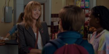 Movie still from “Better Nate Than Ever” (2022), directed by Tim Federle – A woman in a jacket is talking to a boy; Close Up shot, Over the shoulder angle