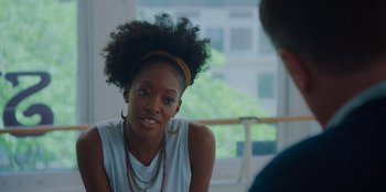Movie still from “Better Nate Than Ever” (2022), directed by Tim Federle – A woman with a yellow headband is talking to a man; Close Up shot, Over the shoulder angle