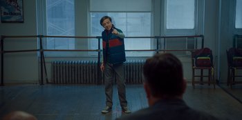 Movie still from “Better Nate Than Ever” (2022), directed by Tim Federle – A young boy standing in front of an audience; Medium shot, Over the shoulder angle