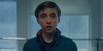 Movie still from “Better Nate Than Ever” (2022), directed by Tim Federle – A young boy stares into the camera; Close Up shot, Low angle