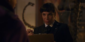 Movie still from “Better Nate Than Ever” (2022), directed by Tim Federle – A woman is looking at a piece of paper; Close Up shot, Over the shoulder angle