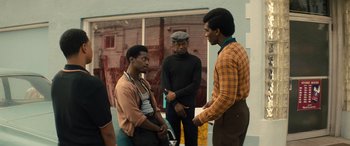 Movie still from “Big George Foreman” (2023), directed by George Tillman Jr. – A group of young men standing next to each other; Medium shot, Over the shoulder angle
