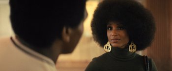 Movie still from “Big George Foreman” (2023), directed by George Tillman Jr. – A woman with a large afro talking to another woman; Close Up shot, Over the shoulder angle