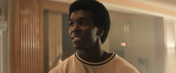 Movie still from “Big George Foreman” (2023), directed by George Tillman Jr. – A person wearing a white shirt; Close Up shot, Low angle