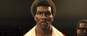 Movie still from “Big George Foreman” (2023), directed by George Tillman Jr. – A person wearing a white shirt; Close Up shot, Low angle