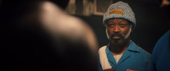 Movie still from “Big George Foreman” (2023), directed by George Tillman Jr. – A person wearing a hat; Close Up shot, Over the shoulder angle