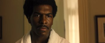 Movie still from “Big George Foreman” (2023), directed by George Tillman Jr. – A person wearing a robe; Close Up shot, Low angle