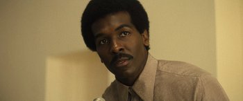 Movie still from “Big George Foreman” (2023), directed by George Tillman Jr. – A person with a microphone; Close Up shot, Low angle