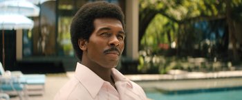 Movie still from “Big George Foreman” (2023), directed by George Tillman Jr. – A man in a white shirt is looking to his left; Close Up shot, Low angle