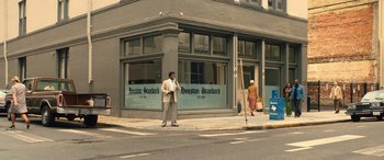 Movie still from “Big George Foreman” (2023), directed by George Tillman Jr. – A man standing on the side of the street talking on a cell phone; Extreme Wide shot, Low angle