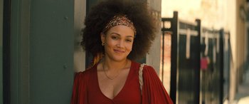 Movie still from “Big George Foreman” (2023), directed by George Tillman Jr. – A woman in a red dress with a headband; Close Up shot, Over the shoulder angle