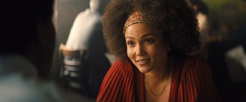Movie still from “Big George Foreman” (2023), directed by George Tillman Jr. – A woman in a red dress with a headband; Close Up shot, Over the shoulder angle