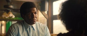 Movie still from “Big George Foreman” (2023), directed by George Tillman Jr. – A man wearing a white shirt and a blue tie; Close Up shot, Over the shoulder angle