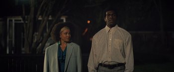 Movie still from “Big George Foreman” (2023), directed by George Tillman Jr. – A man and a woman standing next to each other in front of a tree; Medium shot, Low angle
