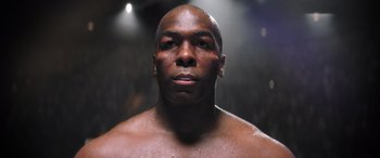 Movie still from “Big George Foreman” (2023), directed by George Tillman Jr. – A man's face in a boxing ring; Close Up shot, Low angle