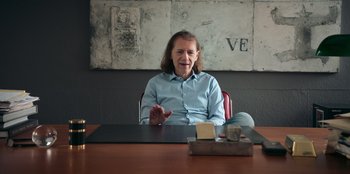 A man sitting at a table in front of a brick wall